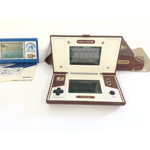 725 - A Boxed Nintendo Donkey Kong Multi Screen , missing battery cover, a unboxed Gakken Donkey Angler wi... 