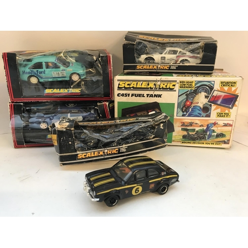 1014 - A Collection of 4 Boxed Scalextric Cars and a Fuel Tank. Boxes Are Worn.