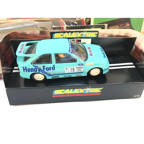 1014 - A Collection of 4 Boxed Scalextric Cars and a Fuel Tank. Boxes Are Worn.