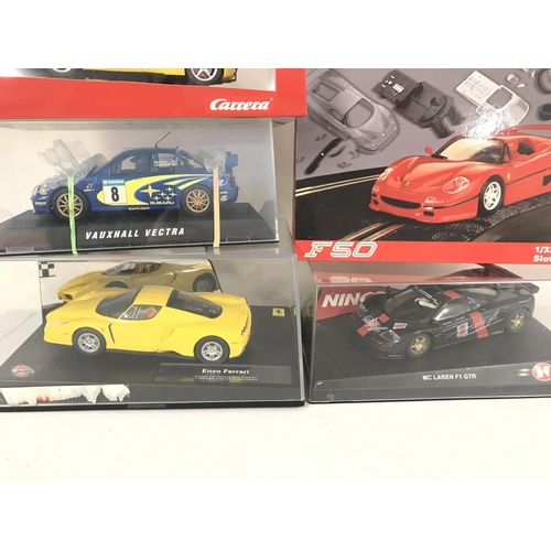 1048 - A Collection of 6 Boxed Slot Cars Including Scalextric. Ninco and Carrera.