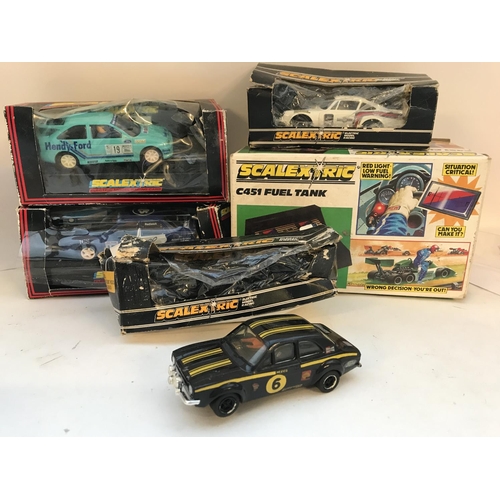 1014 - A Collection of 4 Boxed Scalextric Cars and a Fuel Tank. Boxes Are Worn.