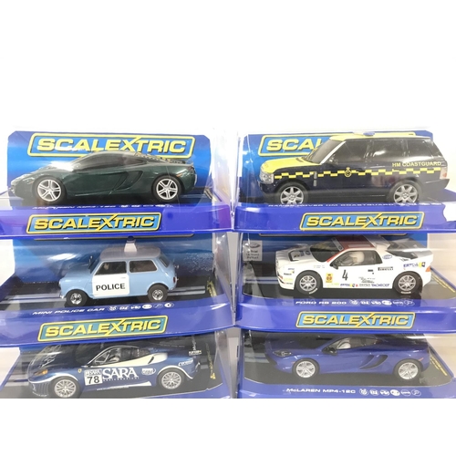 1028 - 6 Boxed Scalextric Cars. 2 x McLaren MP4-12C. A Range Rover HM Coastguard. A Mini Police Car. A Ford... 