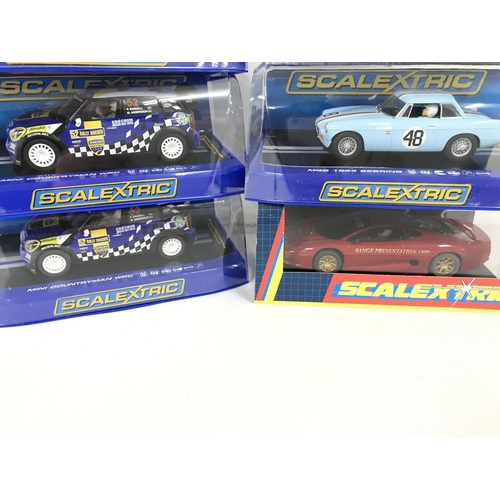 1041 - 6 X Boxed Scalextric Cars. A MG Metro 6R4. 2 X Mini Countryman WRC. A Audi R8 LMS Solo Car. A MGB 19... 