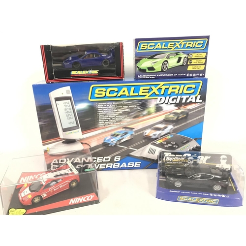 1049 - 3 X Boxed Scalextric Cars. A Boxed Ninco Cars and a Scalextric Advanced 6 Car Powerbase. (2).