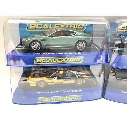 943 - 4 Boxed Scalextric Cars. 2 Aston Martins DB5. A Ferrari 308 GTB and a Ford Escort MK1.