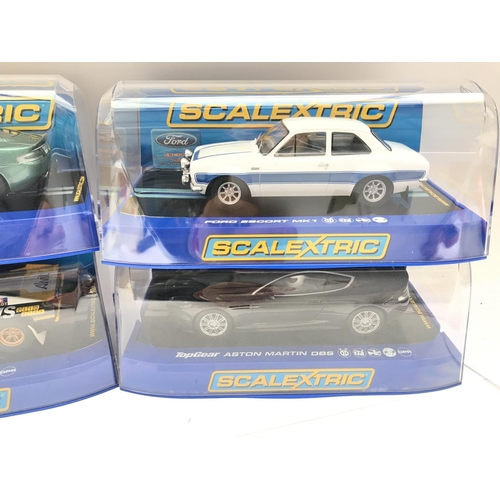 943 - 4 Boxed Scalextric Cars. 2 Aston Martins DB5. A Ferrari 308 GTB and a Ford Escort MK1.