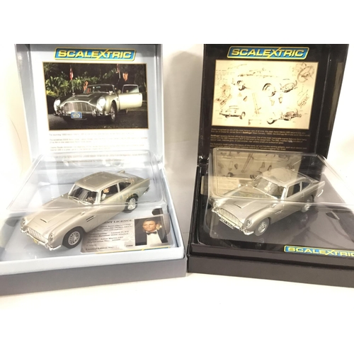 964 - 2 Boxed Scalextric James Bond Cars. Both Aston Martins D.B.5s from Casino Royal and Goldfinger.