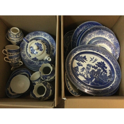 1020 - Two boxes of blue and white ceramics in Old Willow pattern. Shipping category D.