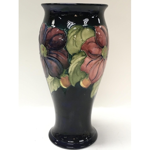 1058 - A Moorcroft Anemone vase, some damage at the bottom of the vase. this lot cannot be posted