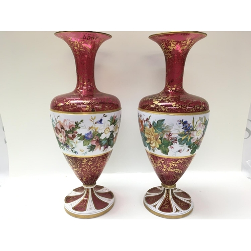 1064 - Two bohemian glass vases with gilt folate decoration, overlaid with flowers and foliage. 39cm in hei... 