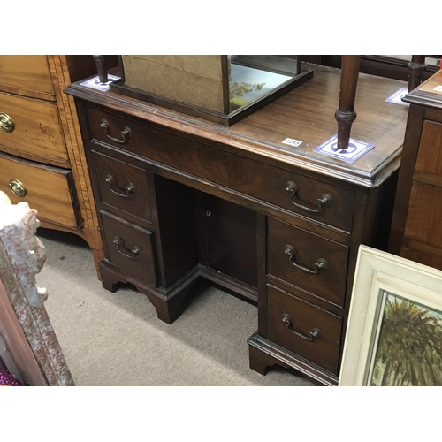 1210 - A George III Mahogany kneehole desk fitted with one long drawer and graduating drawers on bracket fe... 