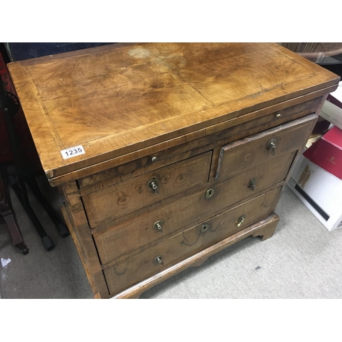 1212 - A Georgian walnut bachelors chest with brushing slide fitted with two short and two long drawers. On... 