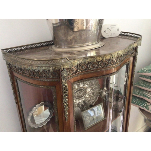 1222 - A French late 19th century walnut display cabinet with gilt metal mounts and serpentine glass door e... 