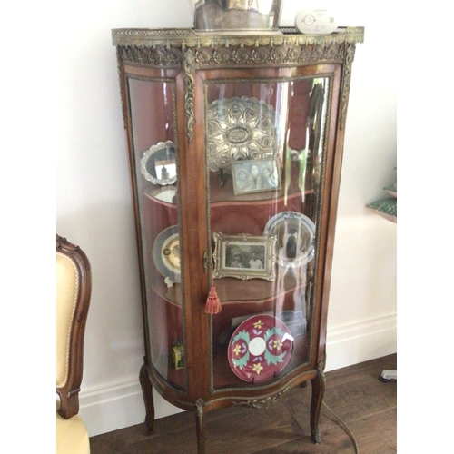 1222 - A French late 19th century walnut display cabinet with gilt metal mounts and serpentine glass door e... 