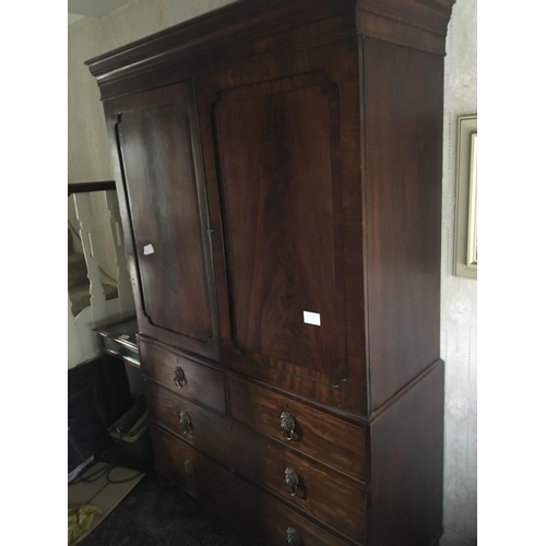 1231 - A late George III mahogany linen press with a cornice above cupboard door enclosing sliding shelves ... 