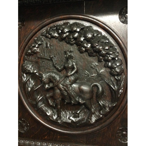 1252 - A large oak sideboard profusely carved with figures horses flower heads And foliage the raised back ... 