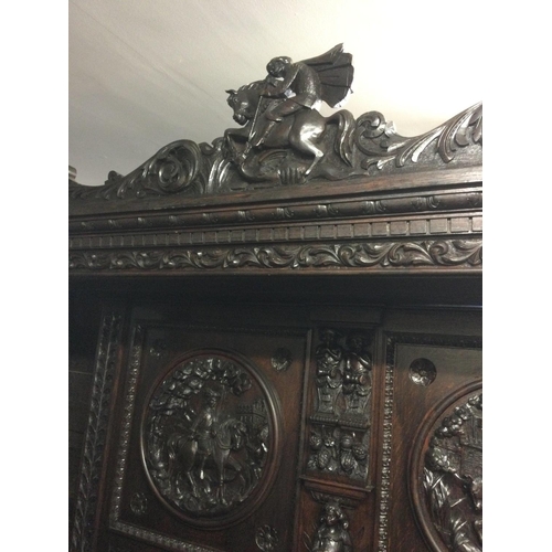 1252 - A large oak sideboard profusely carved with figures horses flower heads And foliage the raised back ... 