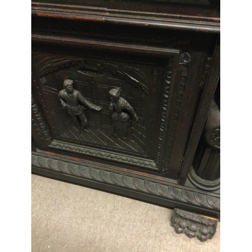 1252 - A large oak sideboard profusely carved with figures horses flower heads And foliage the raised back ... 