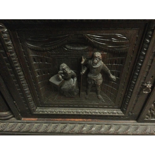 1252 - A large oak sideboard profusely carved with figures horses flower heads And foliage the raised back ... 