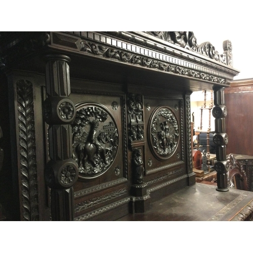 1252 - A large oak sideboard profusely carved with figures horses flower heads And foliage the raised back ... 