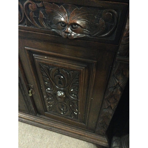 1253 - A oak mirror back sideboard the raised back above two drawers and cupboards under on ball shaped fee... 