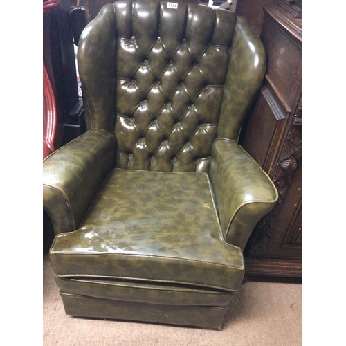 1254 - A green leather button back open armchair.