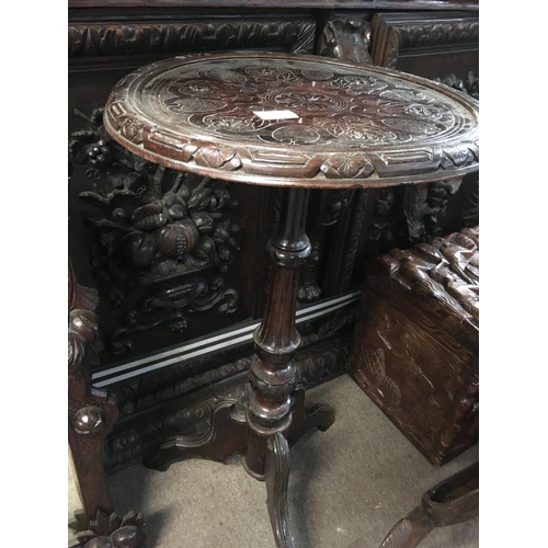 1264 - A small mirror carved with a figure head and a Victorian carved wine table .