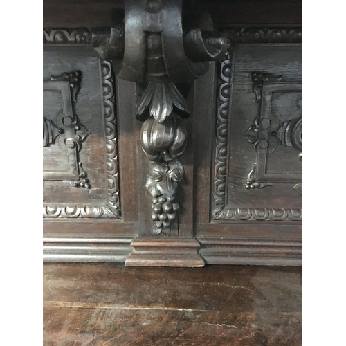 1265 - A large oak Sideboard profusely carved With figures, animals,fruit and foliage the raised back with ... 