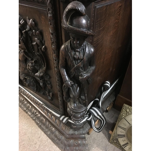 1265 - A large oak Sideboard profusely carved With figures, animals,fruit and foliage the raised back with ... 