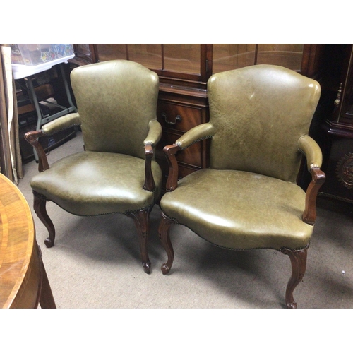 1287 - A pair of quality George III style mahogany open arm chairs.upholstered in green faux leather with s... 