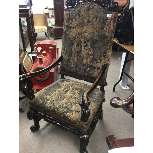 1288 - A Charles II style chair with a carved top rail above pictorial tapestry upholstery with scroll arms... 