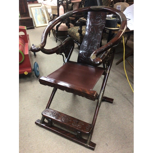 1289 - A quality Chinese folding hardwood and metal mounted chair with a leather seat. Height 97cm