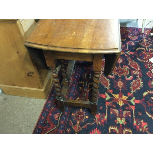 1297 - A table with drop sides and barley legs.