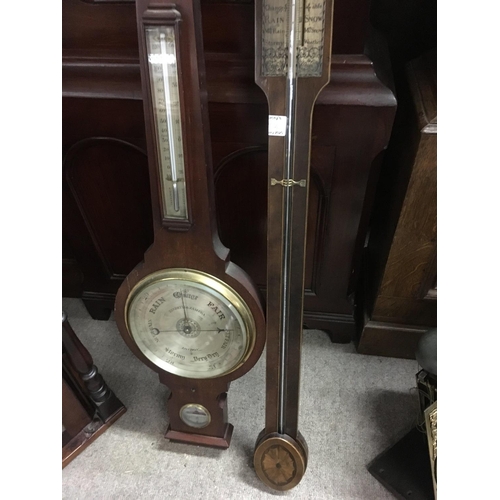 1304 - A mahogany stick barometer and one other barometer.