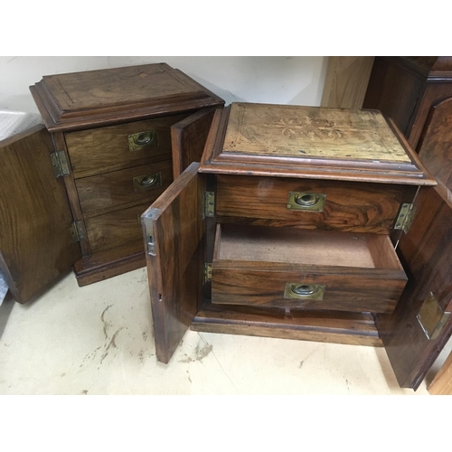1321 - A pair of walnut small collectors cabinets with a pair of inlaid doors enclosing three drawers