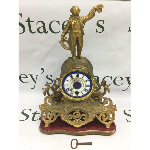 1323 - A French gilt ormolu mantle clock with painted enamel dial and with a finely dressed gentleman to th... 