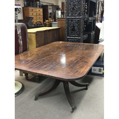 1342 - A George III mahogany tip action dining table with a cross-banded edge on splayed inlaid legs termin... 