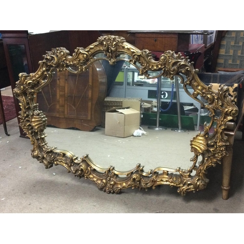 1362 - A wide composition gilt mirror 160cm wide 106cm tall. This lot cannot be posted