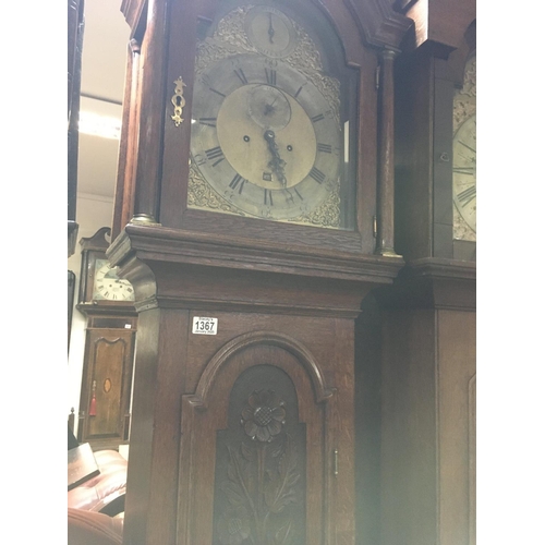 1367 - A oak carved long case clock the arched brass dial with Roman numerals.