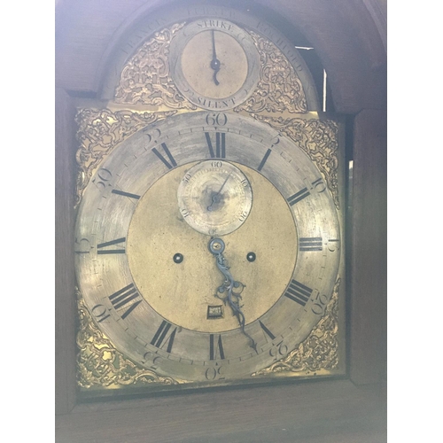 1367 - A oak carved long case clock the arched brass dial with Roman numerals.