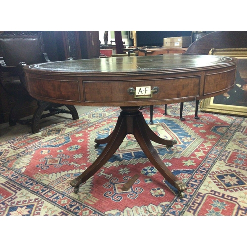 1393 - A George III style Mahogany Rent table the circular top with green leather above drawers with applie... 