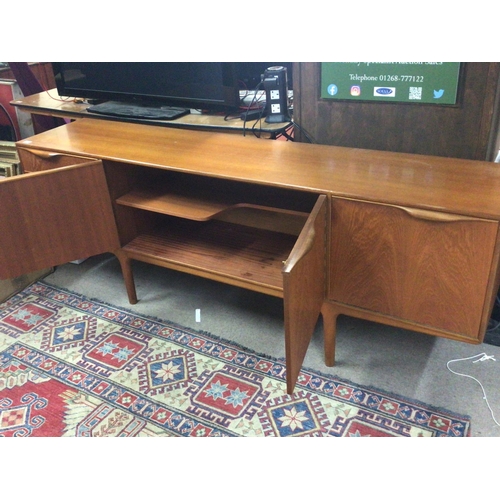 1404 - A Mid 20th century Teak sideboard fitted with cupboards and drawers.