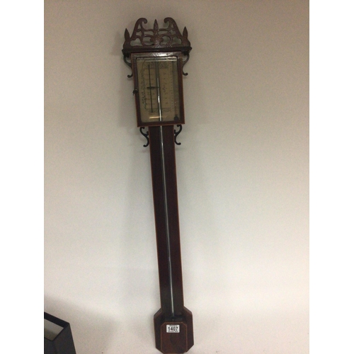 1407 - A stick barometer with a pierced applied pediment with Mercury tube on a mahogany back board with cr... 