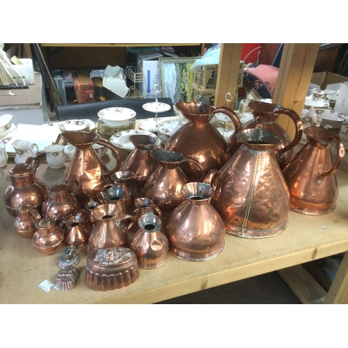 1826 - A large collection of antique copper jugs, measures, jelly moulds etc. Shipping category D.