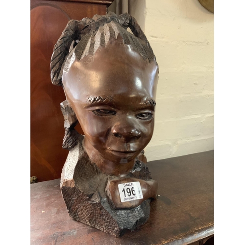 1969 - An African carved hardwood sculpture of a child, 32cm.