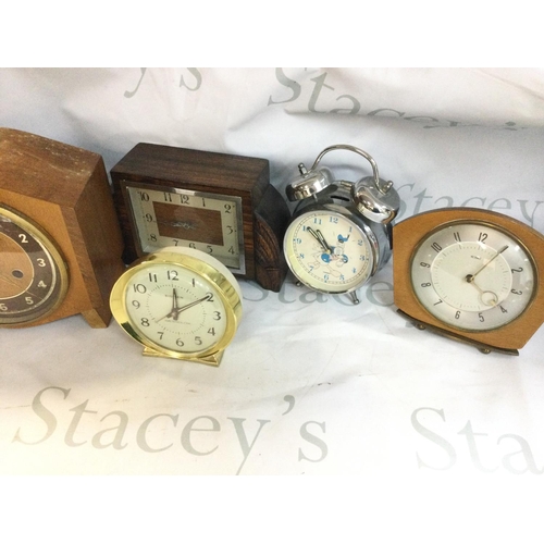 1995 - A collection of clocks including mantle clocks and alarm clocks.