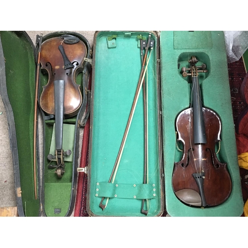 2000 - Two cased vintage violins including a stradivarius Copy, both violins in need of restoration. Postag... 