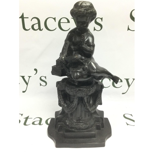 813 - A bronze figure of a cherub seated amongst various books and raised on a column, approx height 35.5c... 