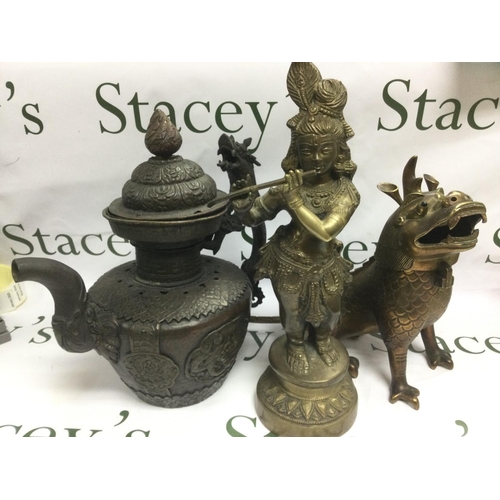 934 - A large Oriental metal teapot, a brass dragon and a female Tibetan figure (3). Shipping category D.