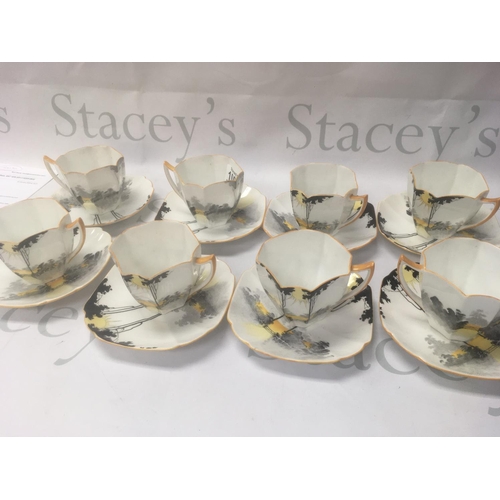 1002 - A set of eight Shelly cups and saucers Tall trees sunset pattern.